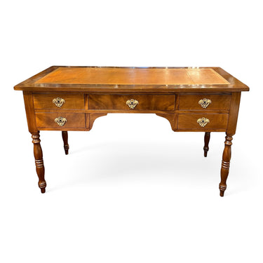 Bucarest Art & Antiques Louis-Philippe mahogany desk with brown leather top, five drawers, and ornate bronze hardware.