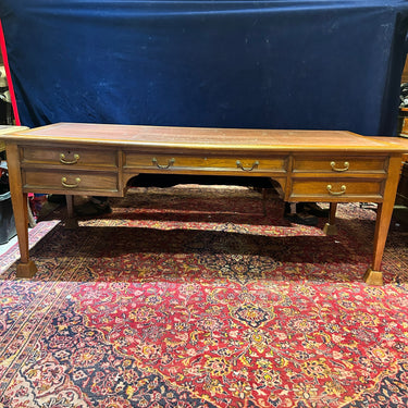 Bucarest Art & Antiques mahogany English desk by Maple & Co. featuring a leather top, brass pulls, and side extensions.